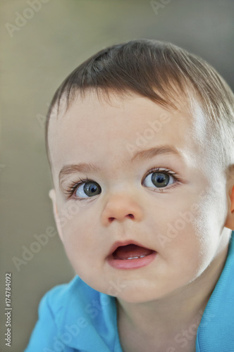 Closeup of baby boy s face with large eyes and eyelashes