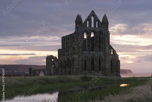 Monastery ruins in sunset light, Whitby Abbey, North Sea at back, Yorkshire, Great Britain, Europe photo