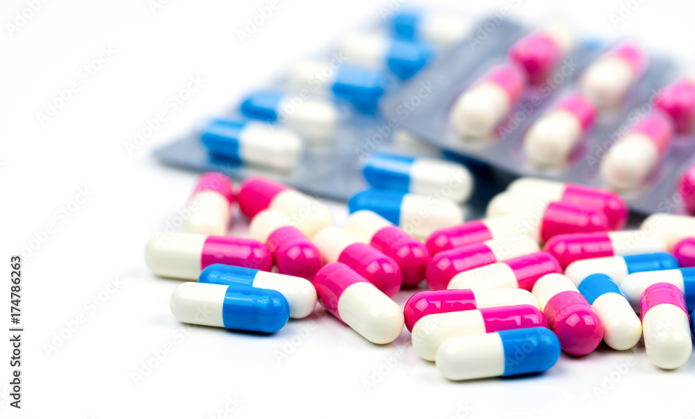 Colorful of antibiotic capsules pills selective focus on blur background with copy space. Drug resistance, antibiotic drug use with reasonable, health policy and health insurance concept.