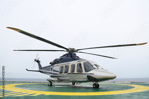 Fototapeta Naklejka Na Ścianę i Meble -  helicopter parking landing on offshore platform, Helicopter transfer crews or passenger to work in offshore oil and gas industry, air transportation for support passenger, ground service in airport.