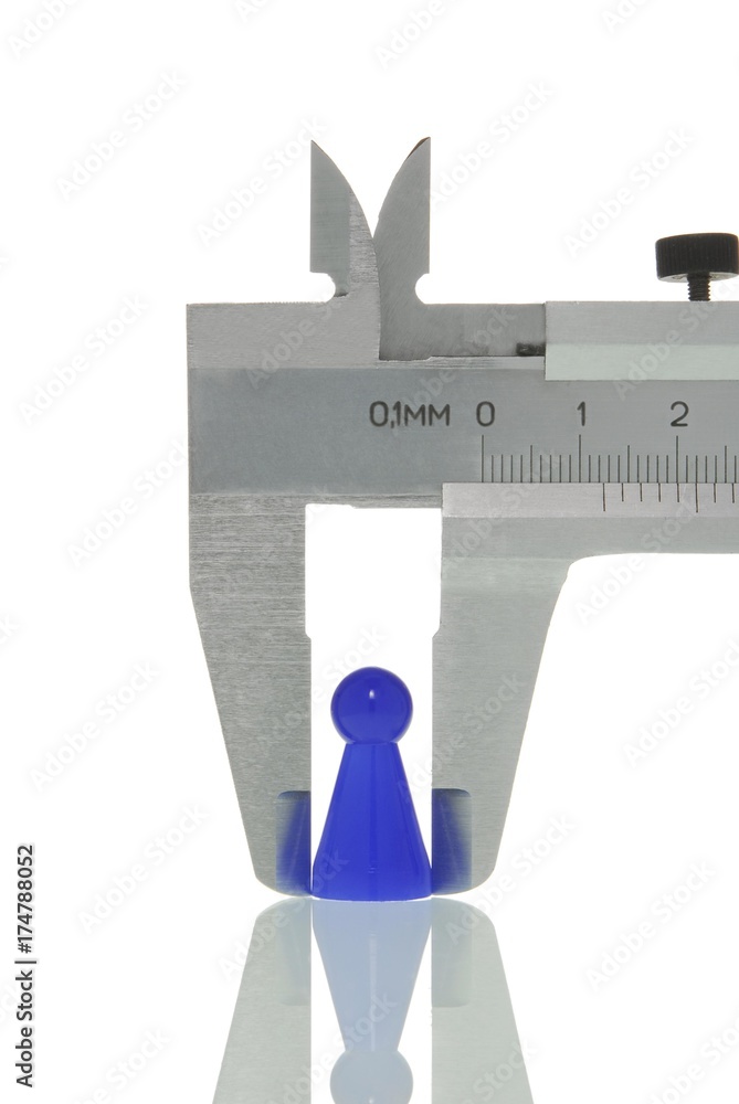 Calipers with a game piece, symbolic image for analysis of a human Calipers with a game piece, symbolic image for analysis of a human