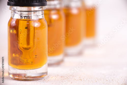 Vials of CBD oil, cannabis live resin extraction isolated on white - medical marijuana concept