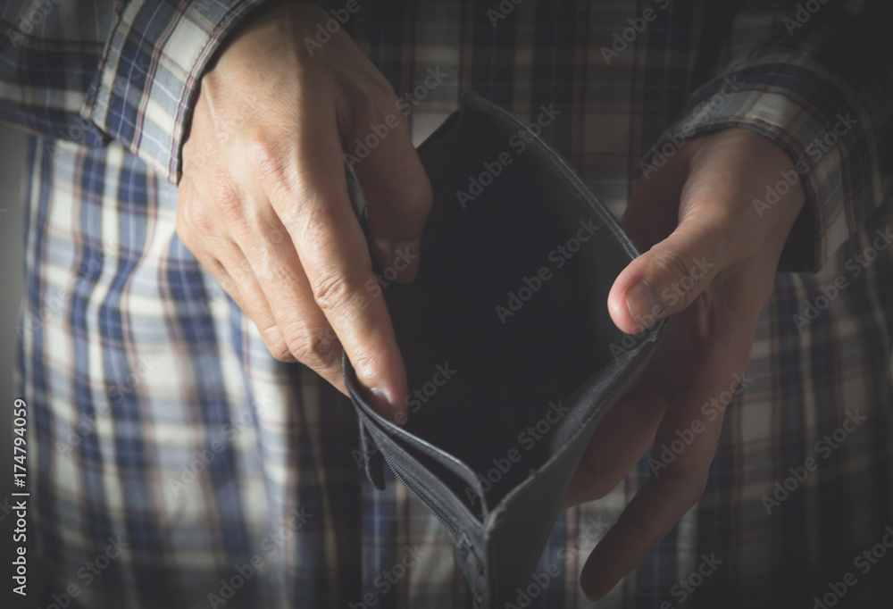 Close-up woman standing and holding the wallet empty of money Close-up woman standing and holding the wallet empty of money