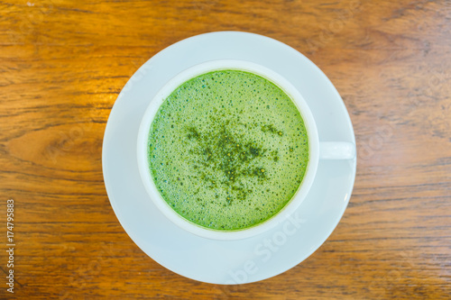 Hot green matcha latte in white cup