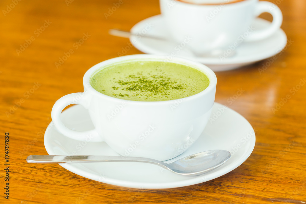 Hot green matcha latte in white cup