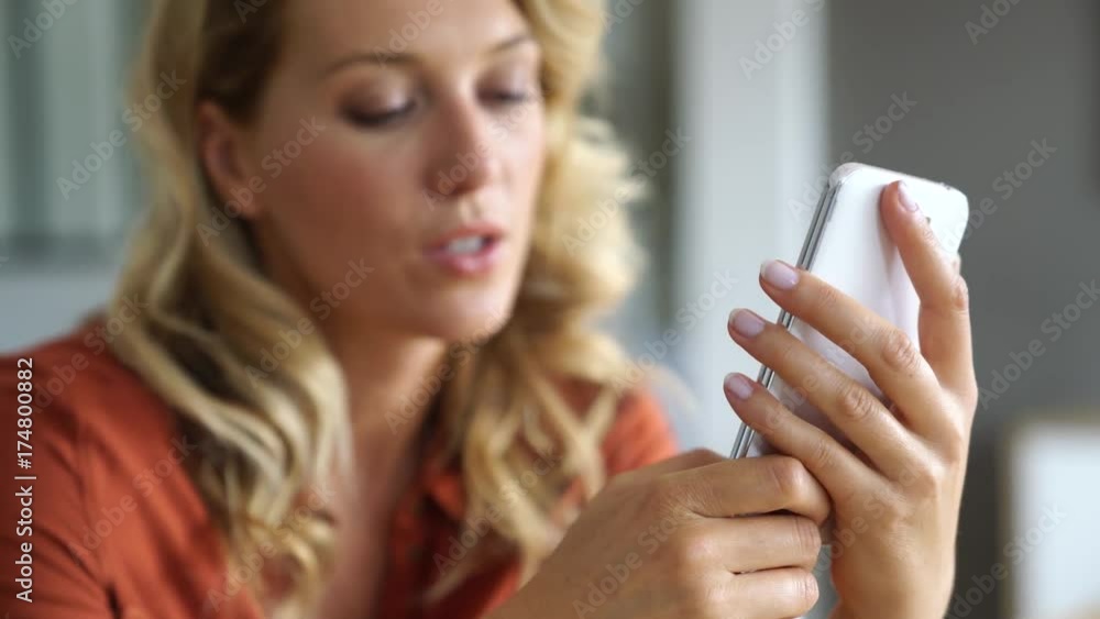 Middle-aged blond woman using smartphone Middle-aged blond woman using smartphone