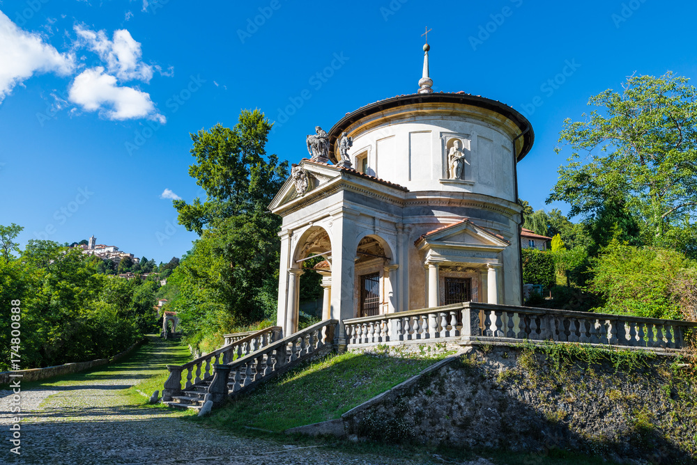 Sacro Monte of Varese (Santa Maria del Monte), Italy. Via Sacra that leads to medieval village, with the seventh chapel. In the background the village of Sacro Monte. World Heritage Site - Unesco