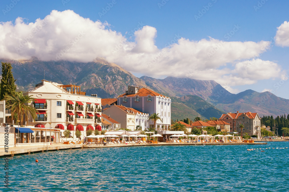 Embankment of Tivat town with mountains in the background on a sunny autumn day. Bay of Kotor (Adriatic Sea), Montenegro
