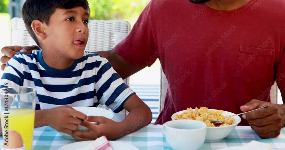 Father and son having breakfast 