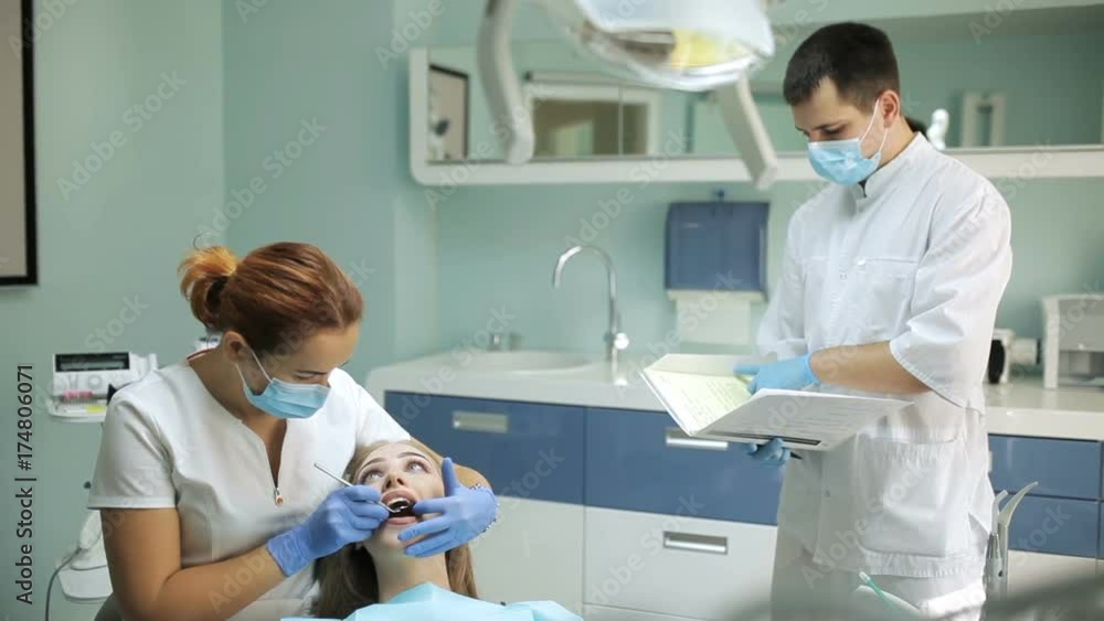 Dentist examining a patient's teeth in the dentistry Dentist examining a patient's teeth in the dentistry