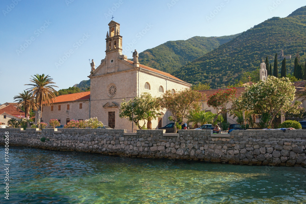 View of seaside Prcanj town and St. Nicholas Church. Kotor Bay of Adriatic Sea, Montenegro