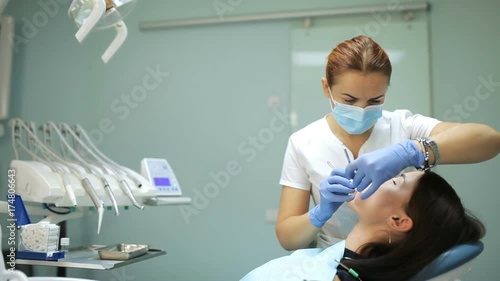 Dentist examining a patient's teeth in the dentistry photo