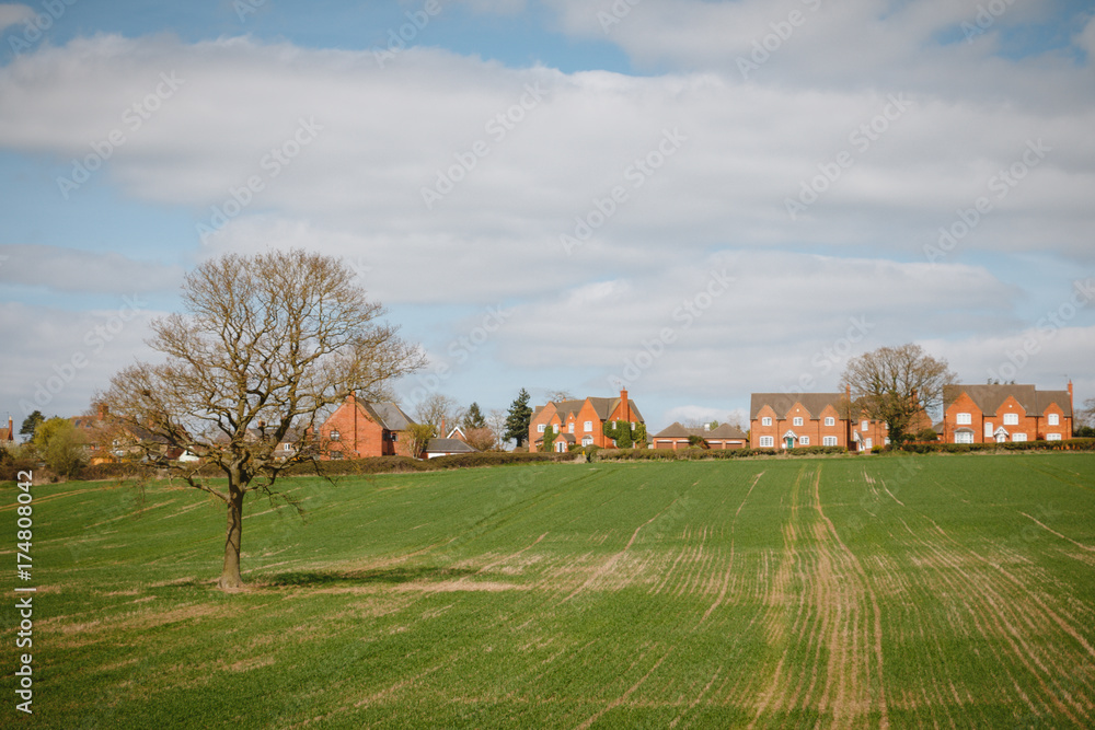 a typical english UK green countryside landscape mixed land use woods and farming