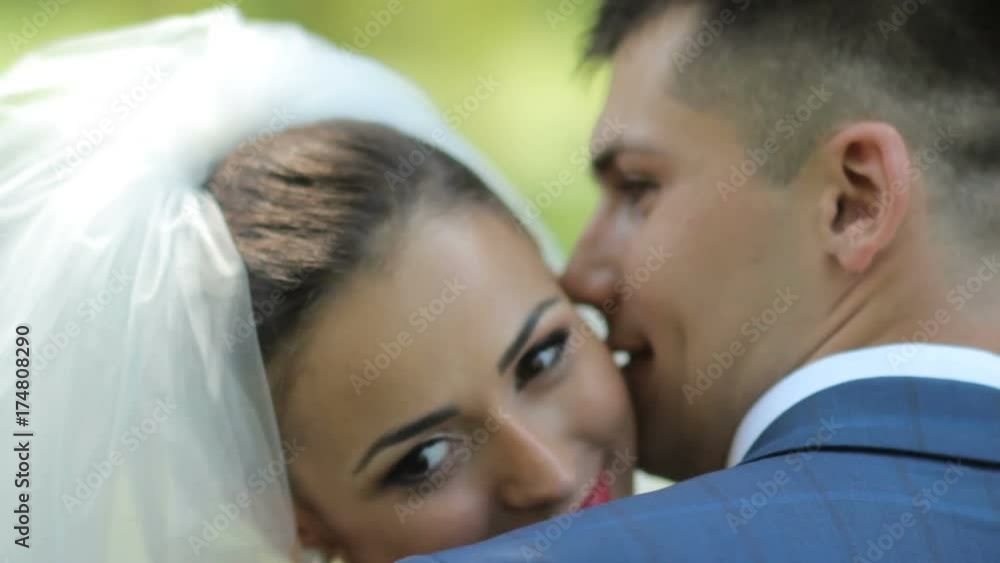 Happy bride and groom on the background of a wooden wall with peonies. gentle hugs of the newlyweds. young couple in love . Portrait of a happy newlywed couple. Happy bride and groom on the background of a wooden wall with peonies. gentle hugs of the newlyweds. young couple in love . Portrait of a happy newlywed couple.