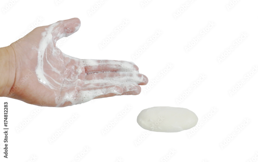 Fototapeta premium soapsuds on human hand and soap cube in white background
