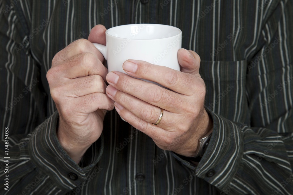 Man's hands holding a coffee cup Man's hands holding a coffee cup
