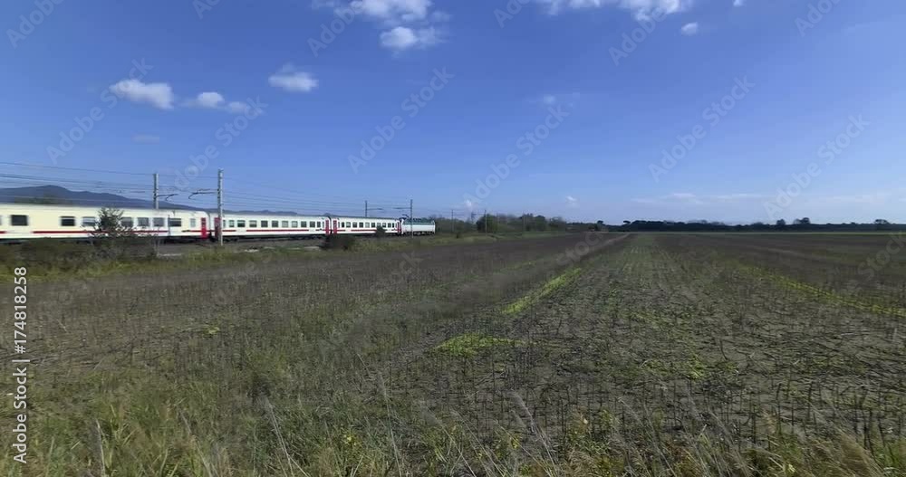 Passenger electric train in transit in an empty land countryside Passenger electric train in transit in an empty land countryside