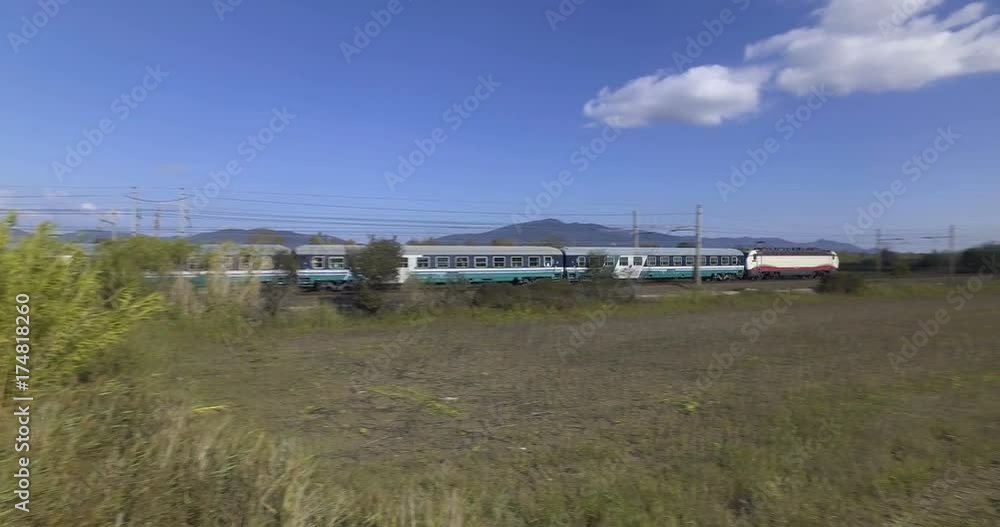 Passenger electric train in transit in an empty land countryside Passenger electric train in transit in an empty land countryside