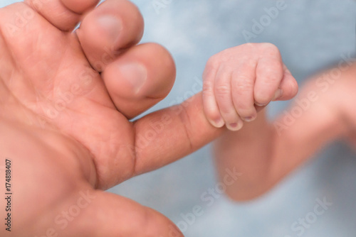 Baby s hand holding finger
