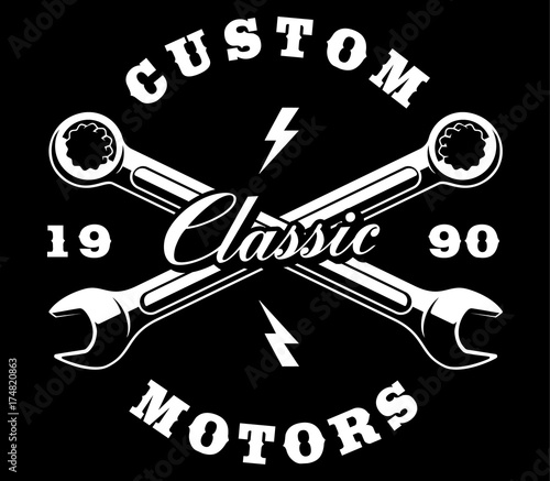 Crossed wrenches on dark background