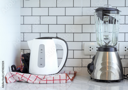 Electric stainless steel kettle and blender on ceramic with plug in kitchen room at home modern white background