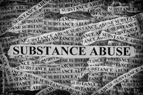Torn pieces of paper with the words Substance Abuse