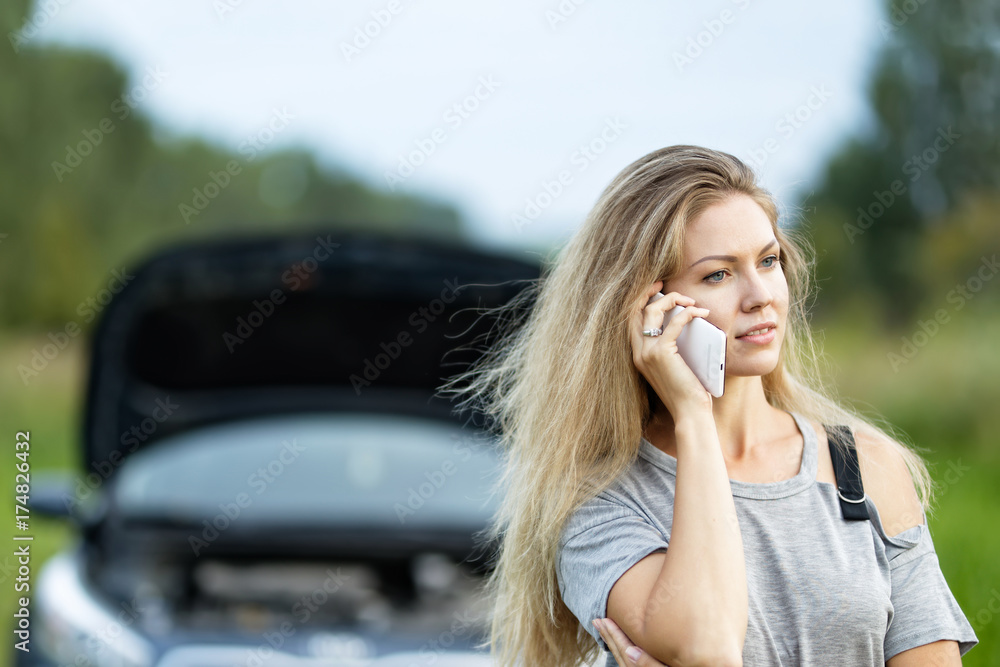 Girl near broken car on road is calling on mobile phone. Girl near broken car on road is calling on mobile phone.