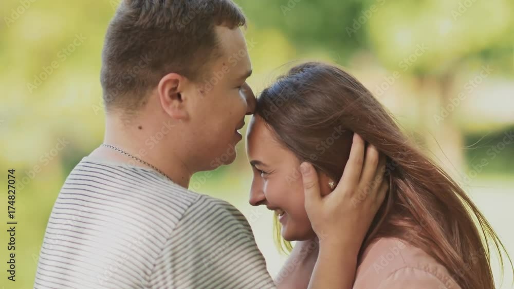 Romantic happy couple together on nature. They look into each other's eyes. Gentle kisses and touches. A loving husband. Romantic happy couple together on nature. They look into each other's eyes. Gentle kisses and touches. A loving husband.