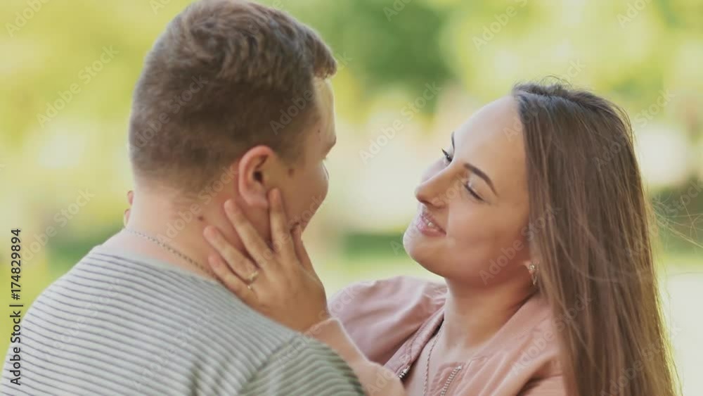 Romantic relationship. Happy couple together on nature. They look into each other's eyes. Gentle touch. The enamored wife. Romantic relationship. Happy couple together on nature. They look into each other's eyes. Gentle touch. The enamored wife.