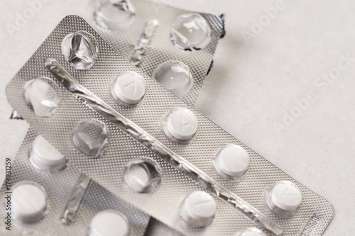 Pharmacy medicine pills isolated on the white marble background