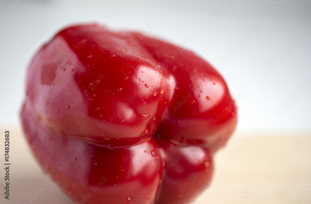 Appetizing fresh red Bulgarian pepper with drops on surface Appetizing fresh red Bulgarian pepper with drops on surface