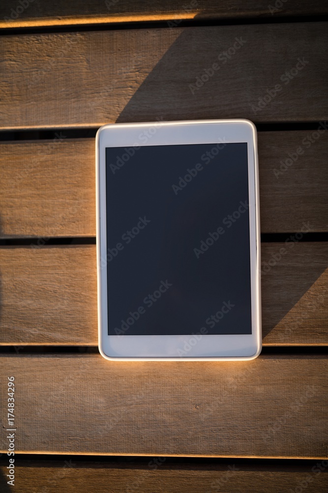 Digital tablet on wooden plank Digital tablet on wooden plank