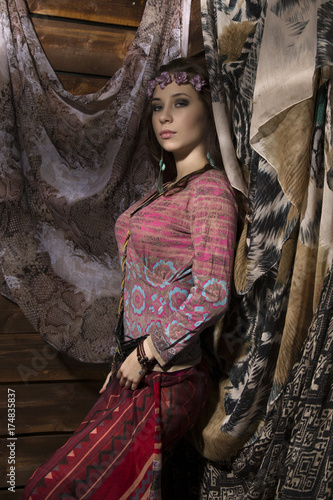 beauty hippie boho woman poses on a wooden background photo