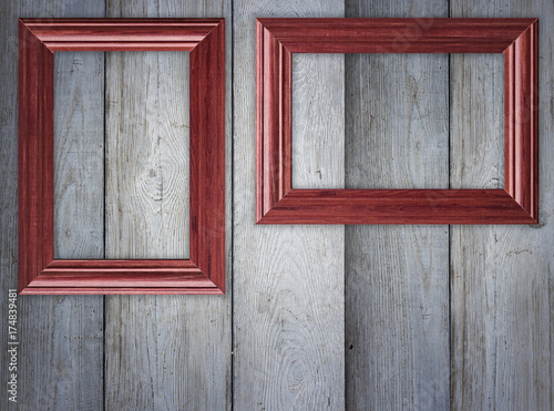 Blank frames on wooden wall