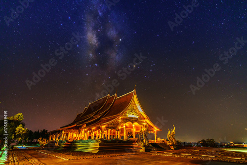 Beautiful Sirindhorn Wararam Phu Prao Temple ( Wat Phu Prao ) with spectacular Milky Way background at night , Ubon Ratchathani province, Thailand