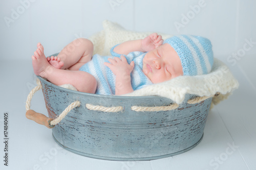 Sweet newborn infant sleeping in little bath