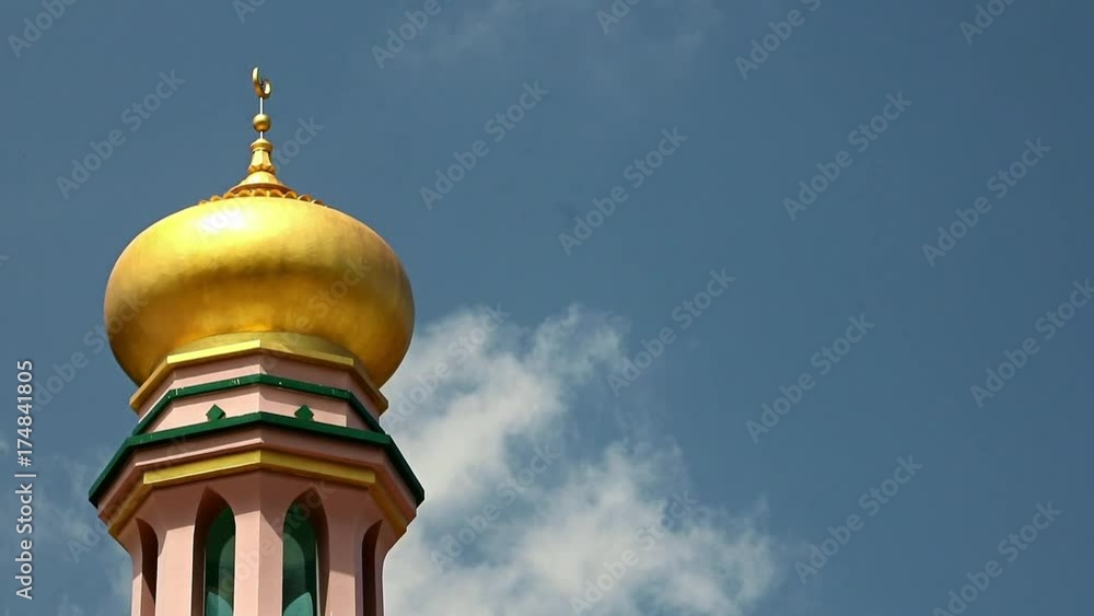 The golden dome of the minaret on a blue background The golden dome of the minaret on a blue background