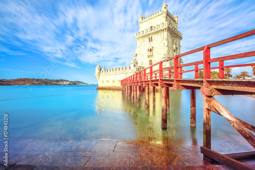 Scenic Belem Tower and wooden dock reflects with low tides on Tagus River.Torre de Belem is Unesco Heritage and symbol of Lisbon, in Belem District, and the most visited attraction in Lisbon, Portugal