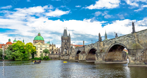 Landscape of the romantic city of Prague under a blue sky. Panoramic view of Charles bridge and old town on a summer day in the capital Czech Republic. Cruise on the Moldovan river. 