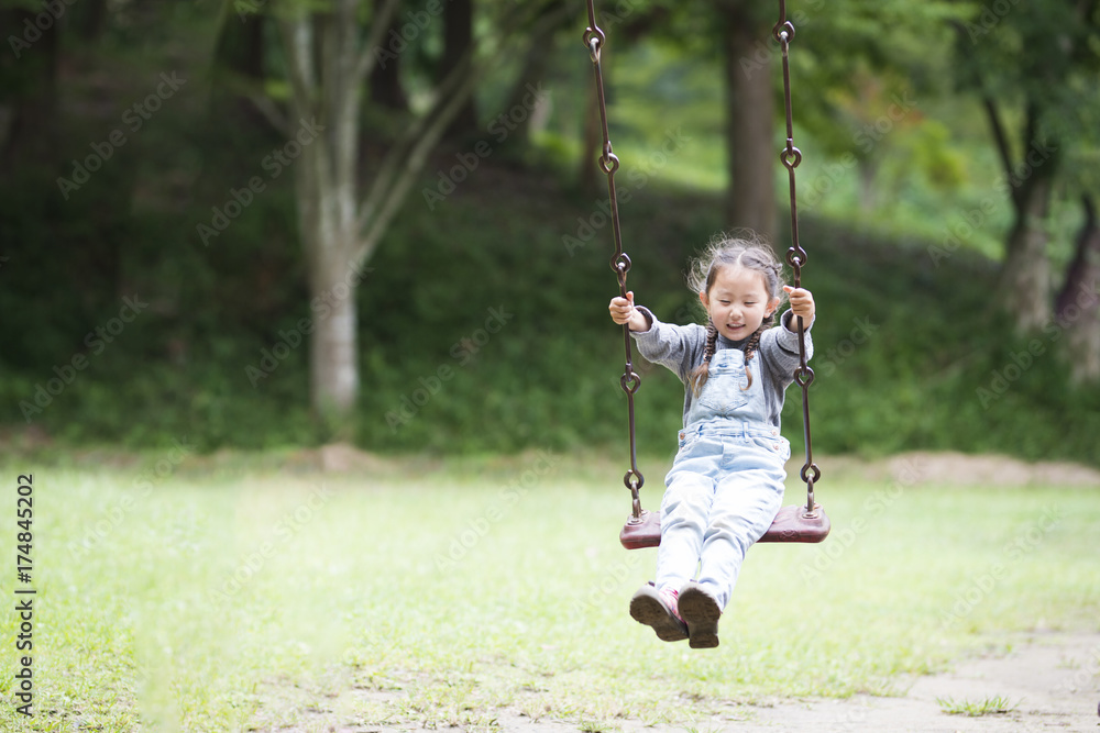 Little girl playing with a swing Little girl playing with a swing