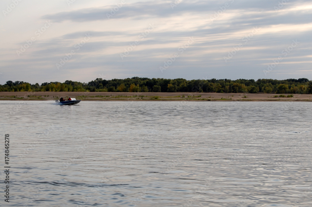 Fishermen ride on a motor boat on the river, Russia, Astrakhan