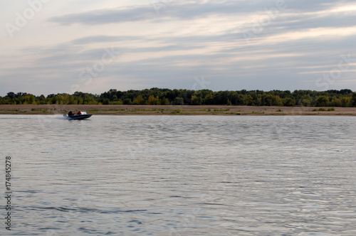 Fishermen ride on a motor boat on the river, Russia, Astrakhan