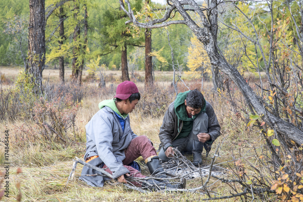 mongolian men making a campfire mongolian men making a campfire