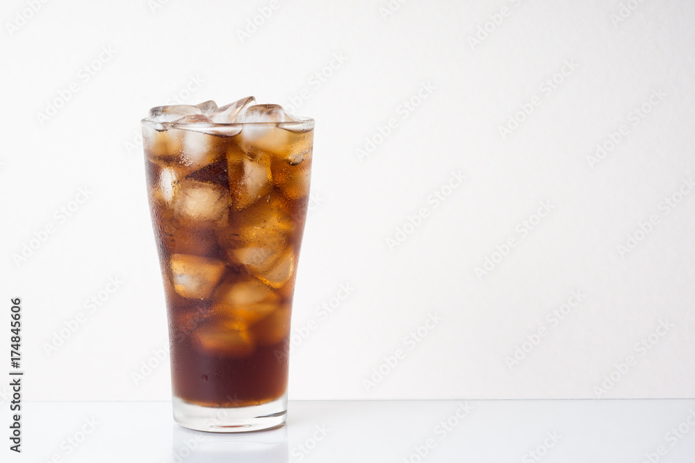 Glass of soft drink,  cola and ice on space of brightness background