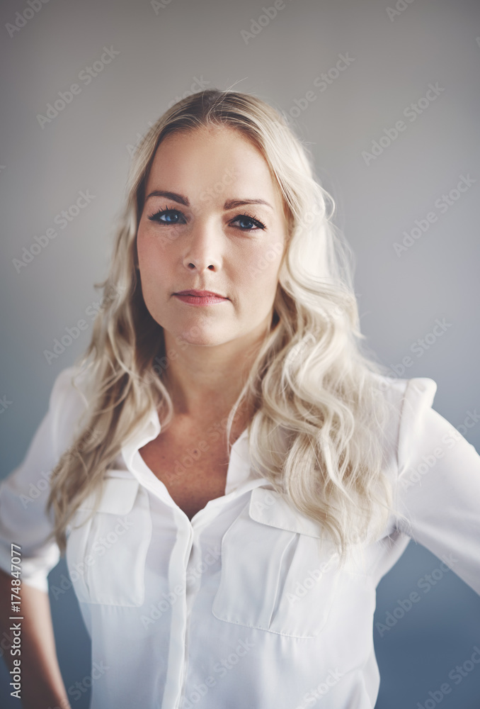 Fototapeta premium Focused young businesswoman standing alone in an office