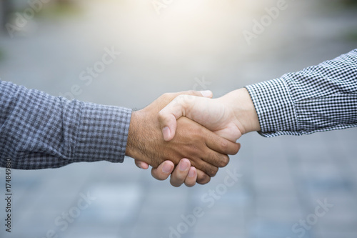 business hand shake between two colleagues Plaid shirt. or Negotiate agreement.Good deal. Close-up of handshaking. Smooth business. photo