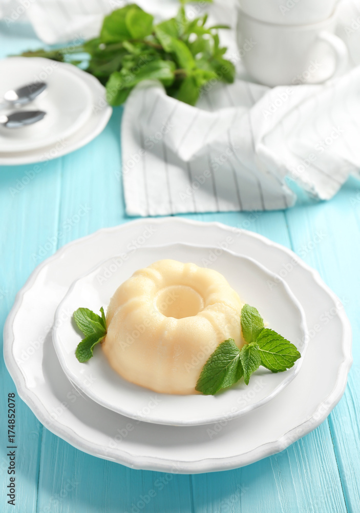 Plate with delicious vanilla pudding on wooden table Plate with delicious vanilla pudding on wooden table