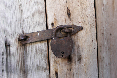 Old lock on wood door © 3azigalka