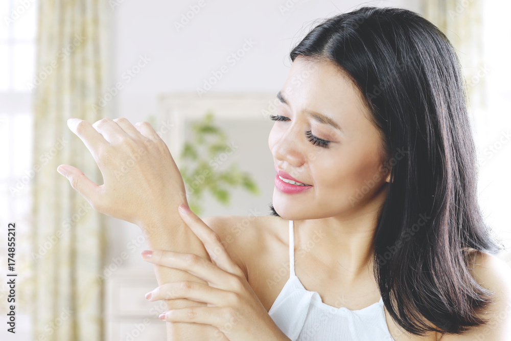 Pretty woman caressing her arm skin healthy