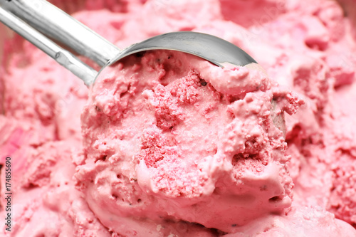 Closeup of scoop with delicious strawberry ice-cream photo